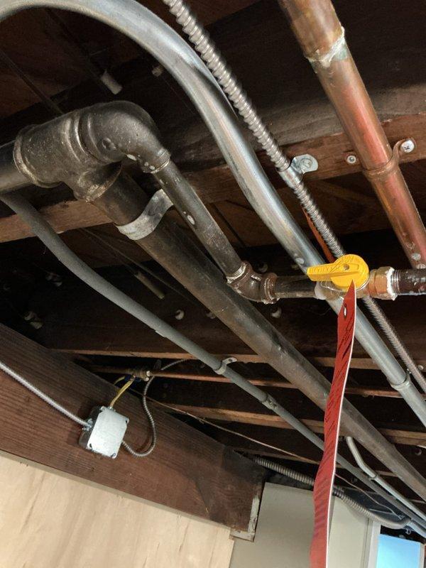 Responded to emergency gas service shutoff at 100-year-old residential property where gas provider had identified leak in basement gas line. Located compromised section of gas piping in basement ceiling joists near yellow-handled gas shut-off valve. Performed pressure test on gas line system to isolate leak location and verify integrity of remaining piping. Repaired defective gas line section using appropriate materials and fittings per code requirements. Conducted final pressure test to confirm leak elimination and system integrity. Coordinated with gas provider for service restoration approval.