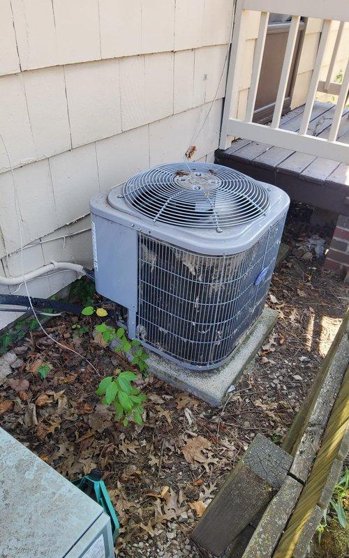 Responded to emergency no-cooling call for residential air conditioning system of unknown age. Upon arrival, performed diagnostic assessment of outdoor condensing unit and indoor air handler/furnace system. Inspected Rheem furnace and associated ductwork in basement utility area, verifying proper connections and airflow pathways. Evaluated outdoor AC unit positioned on concrete pad against exterior wall, checking for operational issues and proper installation. Documented equipment condition through photographic records showing both indoor HVAC components and exterior condensing unit. System assessed and emergency service completed to restore cooling functionality to residence.