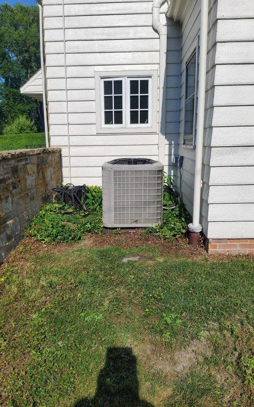# Emergency No Cooling Call - 3-Year-Old System

Responded to emergency no cooling call for a three-year-old residential air conditioning system. Upon arrival, performed visual inspection of outdoor condenser unit, which showed significant dirt and debris accumulation on condenser coil fins and grille louvers. Documented equipment condition with photographs showing the beige/tan condenser unit positioned against house exterior with vegetation growth near base contributing to restricted airflow.

Conducted diagnostic assessment to identify root cause of cooling failure. Checked electrical connections, capacitor values, and refrigerant pressures. Inspected condenser fan motor operation and compressor functionality. Evaluated thermostat communication and indoor air handler performance.

Cleaned condenser coil using appropriate cleaning solution and pressure washing technique to remove dirt buildup affecting heat transfer efficiency. Cleared vegetation and debris from around unit perimeter