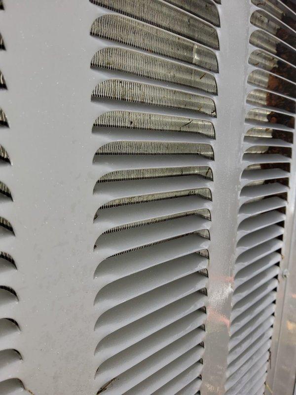 Performed preventative maintenance inspections on four air conditioning systems at commercial facility. Completed comprehensive A/C checks on three air handler units and one package unit, evaluating operational performance, refrigerant levels, electrical connections, and airflow. During inspection, documented significant debris and dust accumulation on condenser coil fins and ventilation louvers, particularly concentrated on upper portions of equipment. Photographed equipment conditions showing heavy dirt buildup affecting heat transfer efficiency on exterior components. Obtained model numbers and documentation photos of combustion unit in boiler room for future replacement planning. All systems assessed for proper operation during moderate ambient temperature conditions.