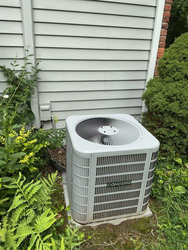 Conducted comprehensive assessment of existing HVAC system for equipment replacement estimate. Evaluated outdoor condensing unit positioned on concrete pad against exterior wall, noting standard residential configuration with vertical louvers and top-discharge fan arrangement. Inspected attic-mounted air handler with associated ductwork, electrical disconnect, and condensate drainage system. Documented current equipment specifications, installation conditions, and surrounding clearances including insulation placement and accessibility constraints. Photographed both indoor and outdoor components to provide detailed visual documentation for replacement proposal and system upgrade planning.