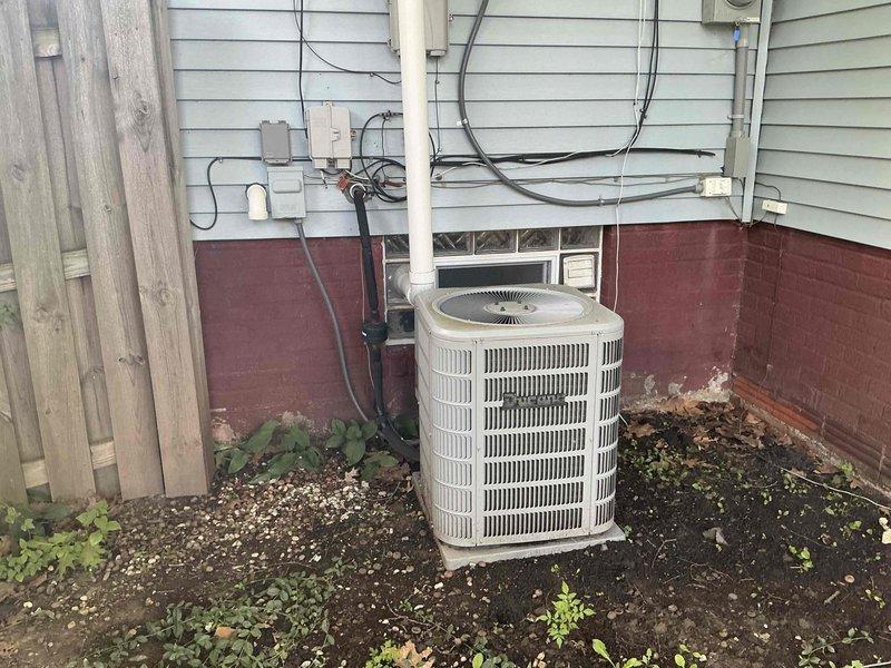 Conducted comprehensive estimate for complete HVAC system replacement at residential property. Evaluated existing furnace installation in basement utility area with connected ductwork system and outdoor AC condenser unit mounted against exterior wall. Documented current equipment configuration, assessed installation requirements, and provided replacement recommendations for both heating and cooling systems.