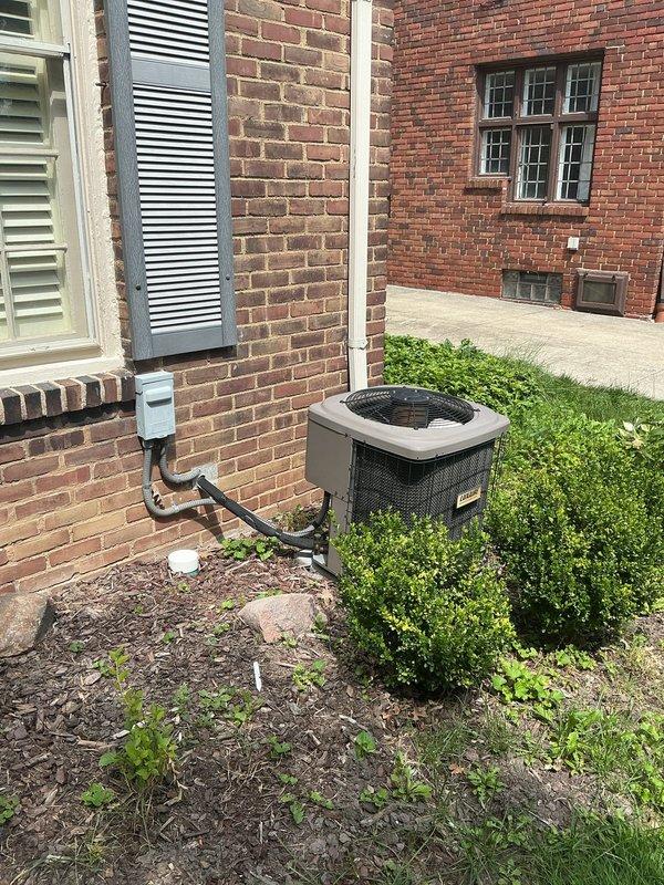 Completed estimate for replacement of 16-year-old residential air conditioning system experiencing no-cool condition. Evaluated existing outdoor condensing unit positioned on concrete pad adjacent to brick exterior and indoor air handler/furnace system located in basement utility area. Documented current equipment configuration including electrical disconnects, refrigerant lines, condensate drainage, and ductwork transitions to provide comprehensive replacement proposal addressing failed cooling capacity.