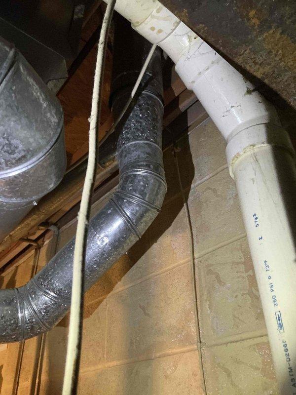Conducted comprehensive HVAC replacement estimate for existing York outdoor condensing unit. Evaluated current system condition, noting standard installation on concrete pad with proper electrical disconnect and adequate clearance from structure. Assessed interior ductwork in basement area, identifying significant condensation issues on flexible metallic supply duct indicating potential insulation deficiency or excessive temperature differential. Documented equipment specifications, installation configuration, and existing ductwork conditions. Provided replacement recommendations addressing both exterior unit upgrade and interior moisture control improvements to ensure optimal system performance and efficiency.