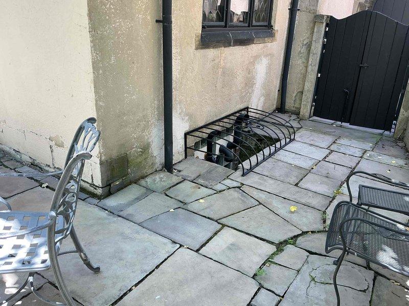 Conducted estimate for 20-year-old air conditioning system experiencing no cooling to third floor. Inspected basement mechanical room containing dual furnace units with associated ductwork, PVC condensate lines, and existing HVAC infrastructure. Evaluated outdoor condenser unit location in courtyard area. Provided replacement options for aging system to restore proper cooling capacity throughout multi-level residence.