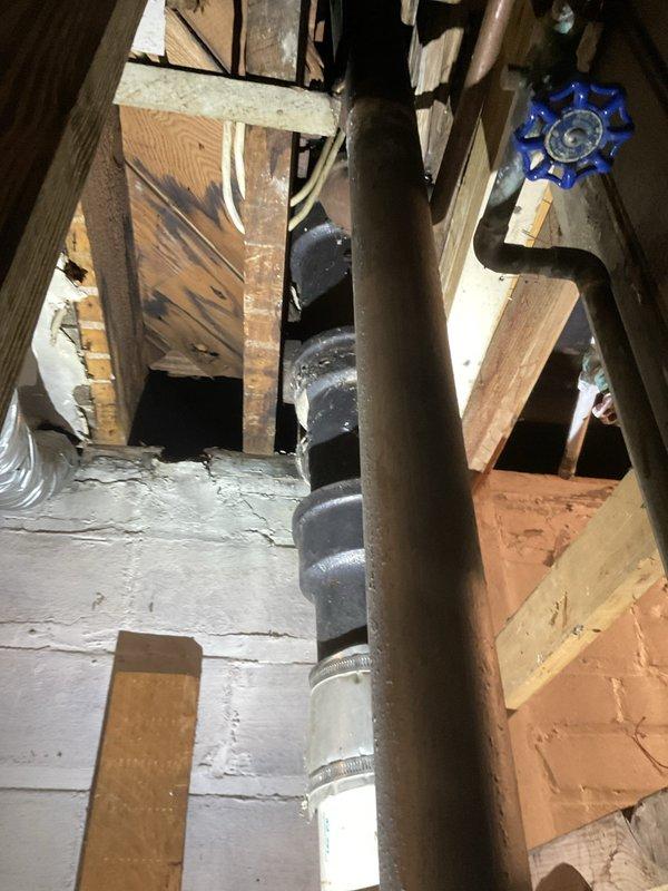 Completed comprehensive plumbing assessment in residential property requiring difficult access to equipment located in attic/crawl space area. Two-person crew relocated homeowner belongings to access vertical cast iron waste stack with blue shut-off valve and transitioned PVC connections secured with metal hose clamps. Acquired necessary permit and installed miscellaneous materials to complete repair work on plumbing infrastructure within exposed framing area.