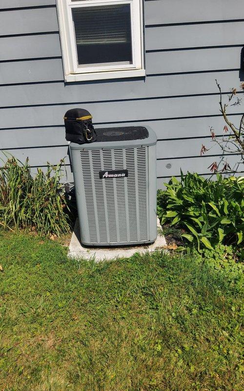 Responded to service call for central air conditioning system not producing cold air. Upon inspection, found severely restricted airflow due to heavily clogged air filter at indoor air handler unit. Removed and replaced dirty pleated filter with new filter, restoring proper airflow to system. Verified Amana outdoor condenser unit operation, confirmed refrigerant pressures within normal range, and tested system performance. Unit now cooling properly with adequate airflow and temperature differential across evaporator coil.