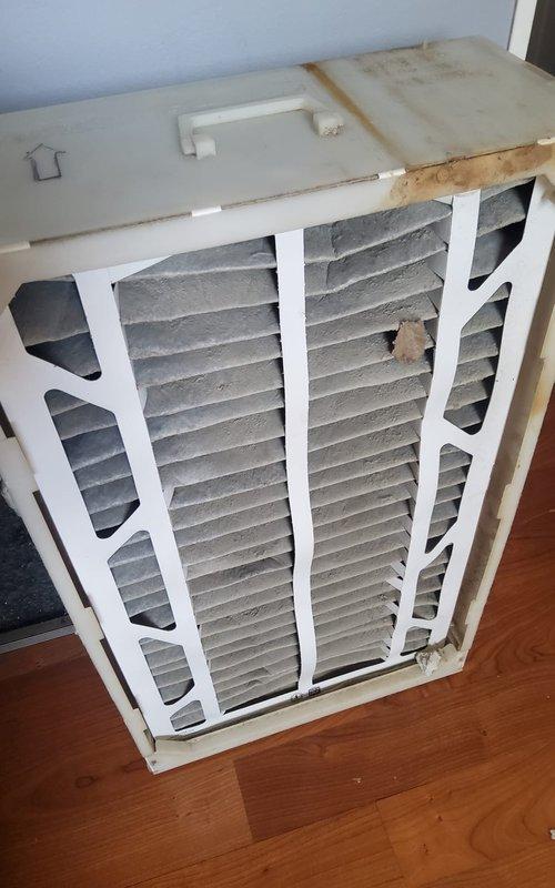 Responded to service call for central air conditioning system not producing cold air. Upon inspection, found severely restricted airflow due to heavily clogged air filter at indoor air handler unit. Removed and replaced dirty pleated filter with new filter, restoring proper airflow to system. Verified Amana outdoor condenser unit operation, confirmed refrigerant pressures within normal range, and tested system performance. Unit now cooling properly with adequate airflow and temperature differential across evaporator coil.