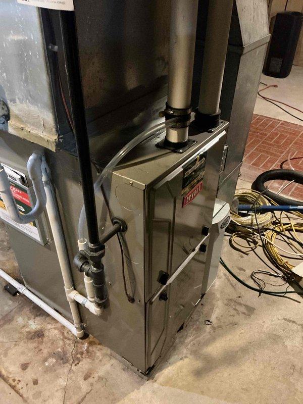 Responded to priority first-call appointment to replace leaking air conditioning system in residential basement mechanical room. Removed and replaced aging AC unit that had developed refrigerant leak of undetermined age. New installation completed alongside existing furnace system that was previously upgraded in 2023, ensuring proper integration with current ductwork, condensate drainage lines, and electrical connections. All PVC piping, refrigerant lines, and duct connections secured and tested for proper operation.