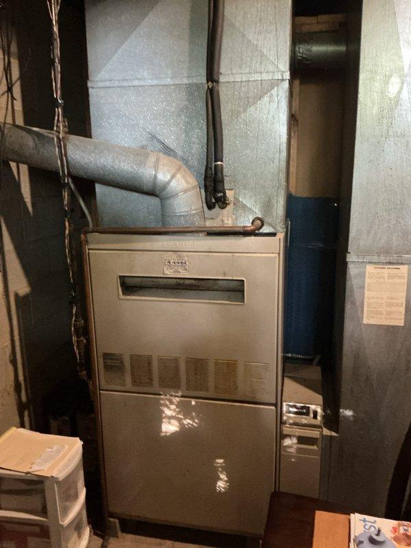 Provided estimate for complete HVAC system replacement including gas furnace and air conditioning unit, both over 20 years old and no longer providing adequate cooling. Assessed existing equipment in basement mechanical room, documented current system configuration with metal ductwork and connections, and presented replacement options to address failed cooling capacity.