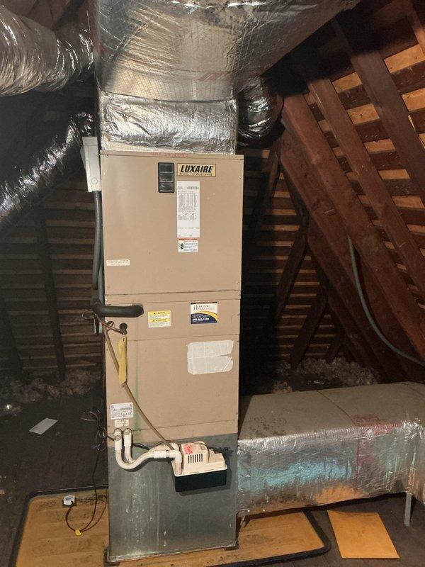 Completed estimate for full HVAC system replacement of approximately 20-year-old equipment. Assessed existing outdoor condenser unit with louvered venting and attic-mounted Luxaire air handler with associated ductwork, condensate drainage system, and auxiliary pump. Documented current system configuration including flexible metallic ductwork, PVC condensate lines, and electrical disconnect for replacement specifications.
