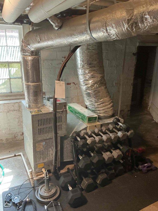 Provided estimate for replacement of existing Unico air conditioning system. Current system operational but experiencing refrigerant leak from evaporator coil. Assessed basement installation including furnace, ductwork configuration, and existing high-velocity AC components to determine replacement specifications and scope of work.