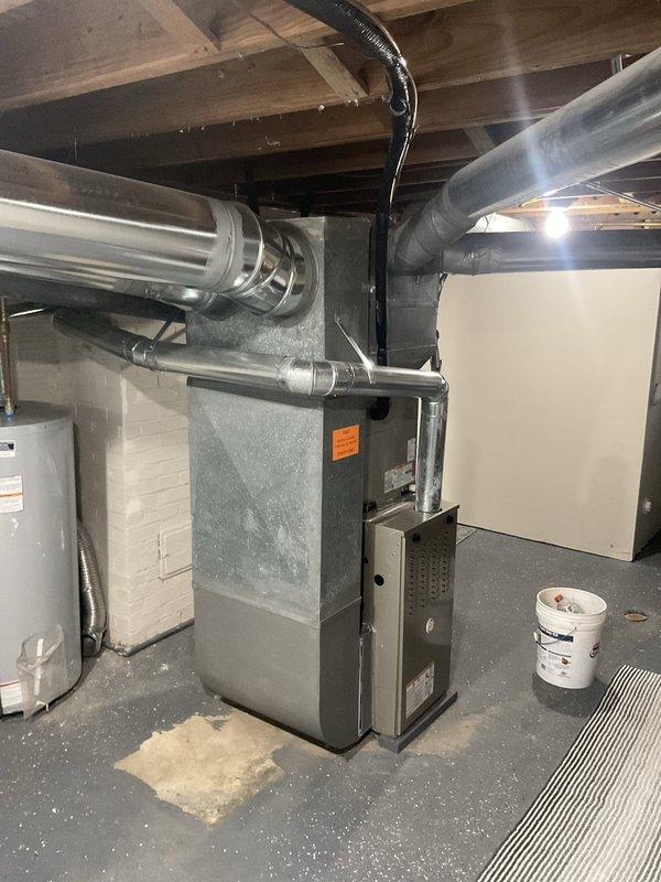 Responded to no cooling complaint on one-year-old Carrier central air conditioning system affecting entire residence. Upon arrival, performed comprehensive system diagnostics including refrigerant charge verification, electrical component testing, and airflow assessment at both indoor air handler and outdoor condensing unit. Documented equipment conditions with photographs showing Carrier furnace with evaporator coil installation in basement mechanical room, noting clean installation with proper clearances and accessible service access points. Completed diagnostic evaluation and identified root cause of cooling failure, restoring system to proper operation with normal temperature differential and adequate airflow throughout residence.