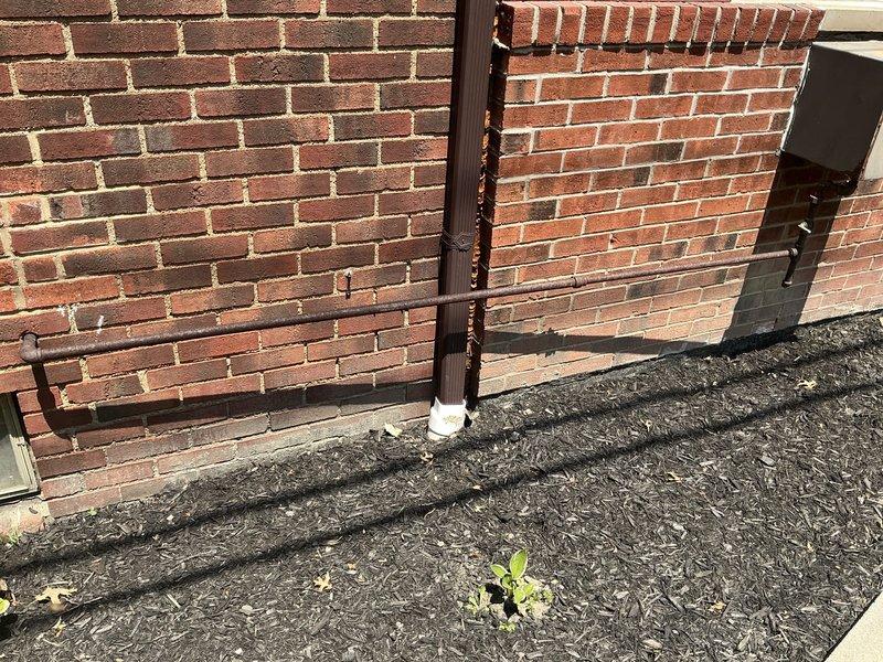 Conducted site assessment for removal of older in-wall natural gas heating unit that had become compromised by a deceased animal inside the system. Documented existing installation conditions including exterior wall-mounted access panel showing signs of weathering and corrosion, and provided estimate for complete unit removal and proper disposal.