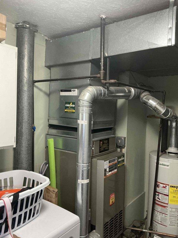 Conducted comprehensive HVAC system evaluation following multiple service calls for inadequate cooling performance. Assessed existing furnace, ductwork configuration, and outdoor condensing unit installation beneath structure. Documented current equipment condition including vertical furnace unit with connected metal ductwork, venting system, and copper refrigerant line set routing through crawl space area. Provided detailed replacement estimate for complete system upgrade to address ongoing cooling deficiencies and restore proper climate control functionality.