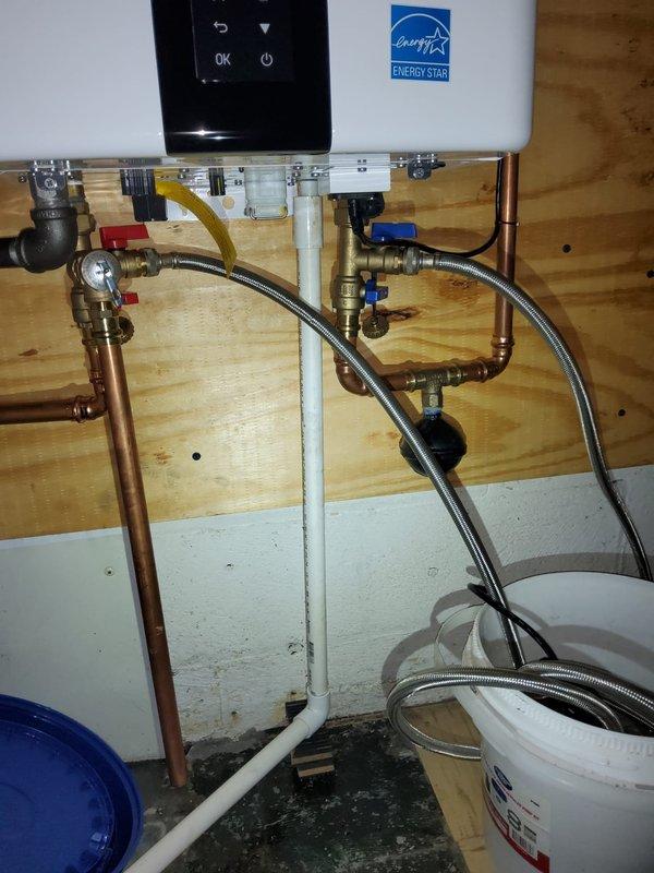 Performed annual maintenance flush on a one-year-old Energy Star certified tankless water heater unit as part of a courtesy plumbing visit. Successfully completed descaling procedure by isolating the unit using the installed service valves, connecting flush equipment via the brass isolation valves with blue handles, and circulating cleaning solution through the heat exchanger to remove mineral buildup and maintain optimal efficiency. Unit tested and returned to normal operation with all connections verified leak-free.
