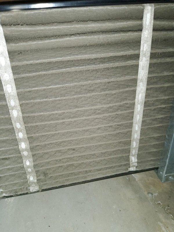 Responded to service call for newly installed AC system experiencing intermittent operation with thermostat displaying "call for service" error message. Upon arrival, performed diagnostic inspection of outdoor condensing unit and indoor air handler. Inspected evaporator coil assembly and found significant dust and debris accumulation on aluminum fins despite recent installation, which could restrict airflow and impact system performance. Documented equipment condition through photographic evidence showing corrugated coil surface with visible contamination and buildup on heat exchanger fins. Evaluated electrical connections, PCB functionality, and overall system operation to identify root cause of intermittent failure and thermostat fault code.