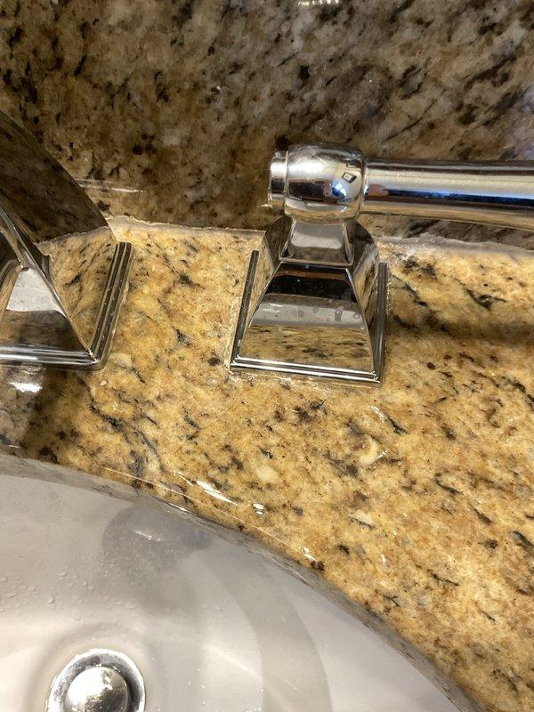 Responded to service call for leaking bathroom faucet in century-old home. Upon inspection, identified worn internal components in chrome widespread faucet assembly mounted on granite countertop. Disassembled faucet handles and spout, replaced deteriorated cartridges and O-rings, and reassured proper seating of all fixtures. Tested for leaks under pressure and confirmed complete seal restoration. All fixtures left in proper working condition with no active leaks detected.