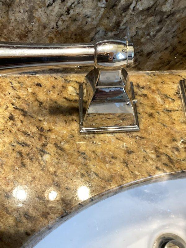 Responded to service call for leaking bathroom faucet in century-old home. Upon inspection, identified worn internal components in chrome widespread faucet assembly mounted on granite countertop. Disassembled faucet handles and spout, replaced deteriorated cartridges and O-rings, and reassured proper seating of all fixtures. Tested for leaks under pressure and confirmed complete seal restoration. All fixtures left in proper working condition with no active leaks detected.