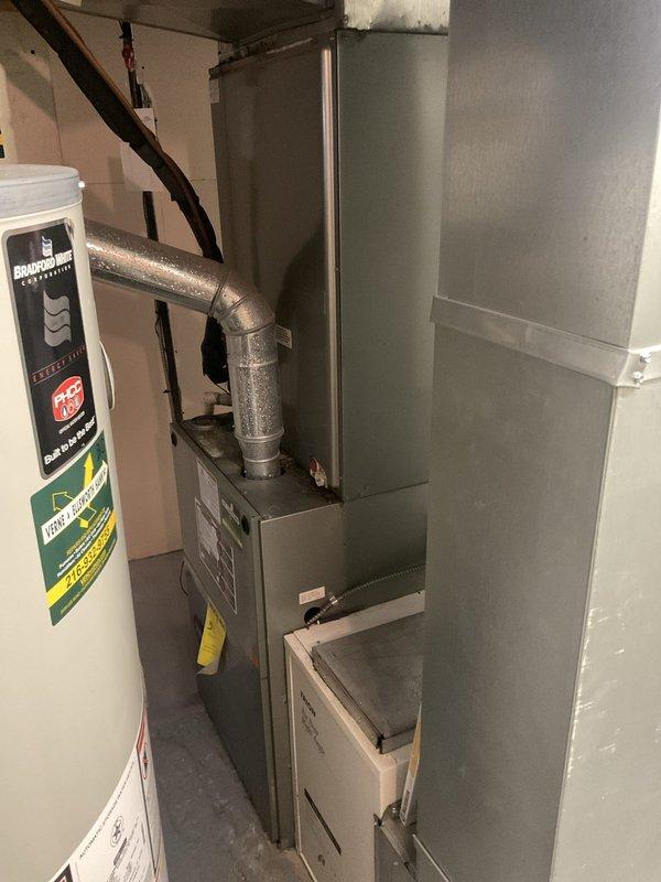 Performed comprehensive routine maintenance on a 15-year-old Rheem air conditioning system (Model RCFL-194482ACC, Serial MG91069758, manufactured 07/2010). Inspected indoor air handler unit located in basement mechanical room and outdoor condensing unit. System was operating properly with no reported issues prior to service. Completed standard AC tune-up procedures including visual inspection of all components, verification of proper airflow through ductwork, checking refrigerant levels, cleaning condenser coils, inspecting electrical connections, and testing system operation. All equipment found to be functioning within normal parameters. Documented equipment condition with photos of indoor unit and manufacturer data plate for maintenance records. System cleared for continued operation with recommendation to monitor performance given age of equipment.