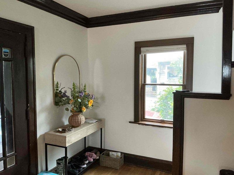 Provided estimate for mini split installation in residential property with dark wood trim and white walls. Assessed multiple interior locations for optimal unit placement, including entryway area with console table and main living space with double-paned windows. Also evaluated site requirements for tankless water heater installation to replace existing system.