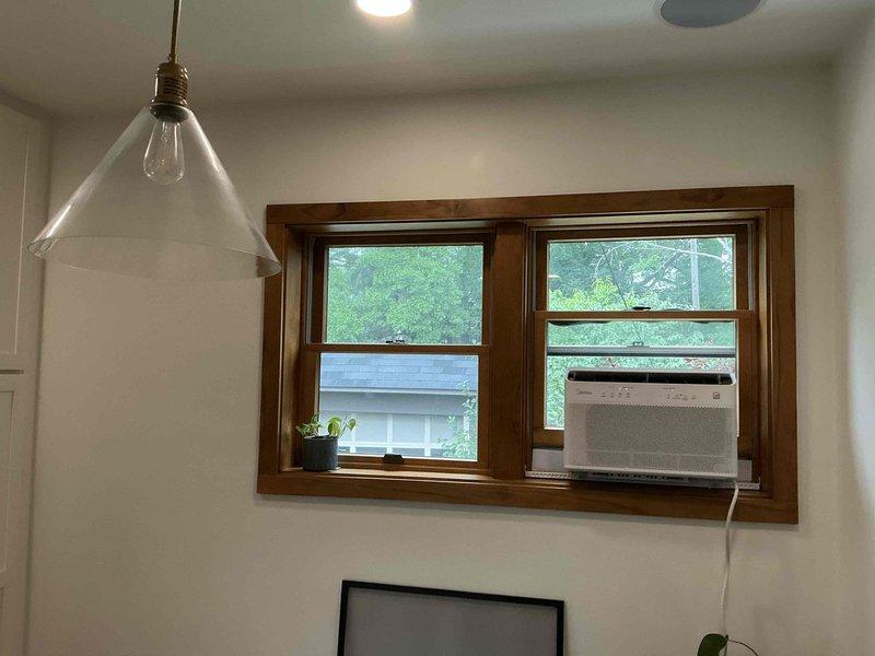 Provided estimate for mini split installation in residential property with dark wood trim and white walls. Assessed multiple interior locations for optimal unit placement, including entryway area with console table and main living space with double-paned windows. Also evaluated site requirements for tankless water heater installation to replace existing system.