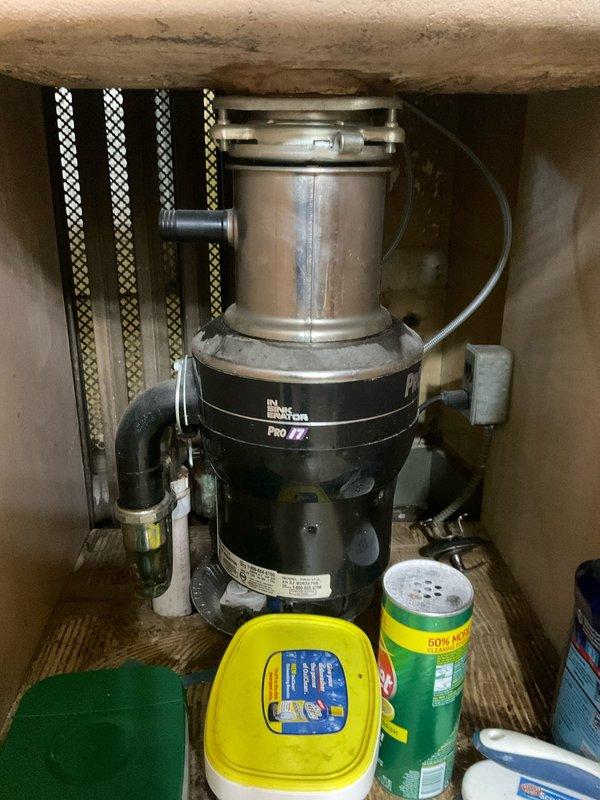 Installed new InSinkErator Pro Series garbage disposal unit in kitchen of 95-year-old home. Completed full installation including mounting assembly, drain connections, and P-trap configuration with PVC piping. Repaired leaking bathroom faucet to restore proper operation and eliminate water waste.