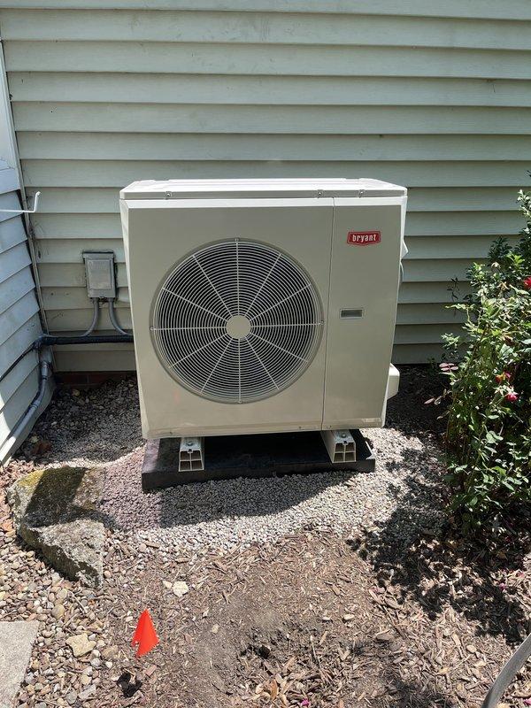 Completed full HVAC system replacement including removal of existing equipment and installation of new Bryant heat pump system with matching furnace and evaporator coil. Installed Ecobee smart thermostat for enhanced climate control and integrated 700CFM fresh air ventilation system. Outdoor heat pump unit mounted on composite pad with proper gravel base and electrical disconnect, while indoor components including furnace and air handler positioned in basement utility area with all refrigerant lines, condensate drainage, and PVC venting properly routed and secured per manufacturer specifications.