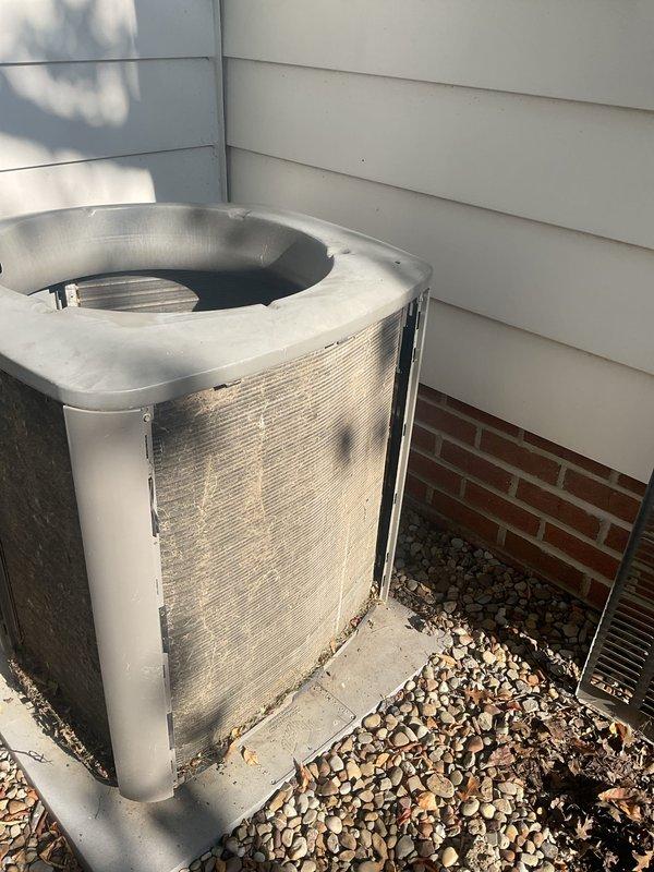 Performed advanced coil cleaning on outdoor condensing unit that had accumulated significant debris, leaves, and dirt buildup affecting system performance. Removed side panels and condenser fan motor to access coil compartment, back-flushed condenser coil to restore proper heat transfer efficiency, and cleared all leaves and organic debris from interior housing around compressor. Reassembled unit and restored to proper operating condition.
