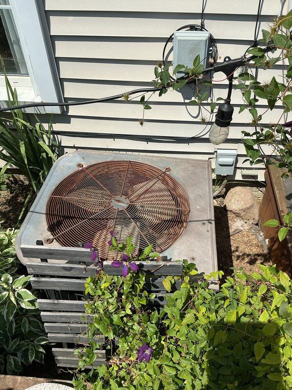 Responded to no cooling complaint and performed comprehensive system evaluation. Upon inspection, found outdoor condenser unit in severely deteriorated condition with significant corrosion on fan grille and cabinet, indicating advanced age and exposure damage. Unit showed signs of neglect with vegetation overgrowth impeding proper airflow and clearance requirements. Provided complete replacement estimate for new HVAC system to restore cooling functionality and improve energy efficiency.