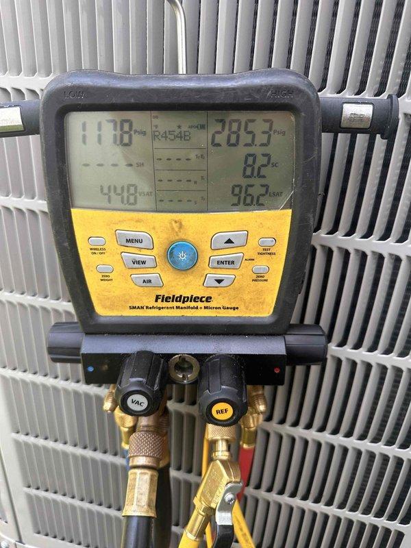 Completed full HVAC system installation featuring new Bryant outdoor condensing unit. Installed equipment on elevated platform with proper clearances from structure, established electrical connections including disconnect box and meter integration, and routed refrigerant lines and condensate drainage. Evacuated system to proper micron levels, charged with R454B refrigerant to manufacturer specifications, and verified operating pressures and system performance using calibrated manifold gauges.