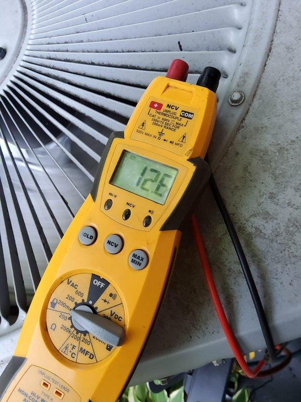 Responded to no cooling complaint on residential air conditioning system. Upon arrival, performed electrical diagnostics using digital multimeter at the outdoor condensing unit. Measured voltage at 133VAC and capacitance reading of 12.2 microfarads at the condenser coil assembly, indicating potential capacitor failure or degradation below manufacturer specifications. Visually inspected condenser coil fins which were found to be clean and in good condition with proper spacing maintained throughout the assembly.