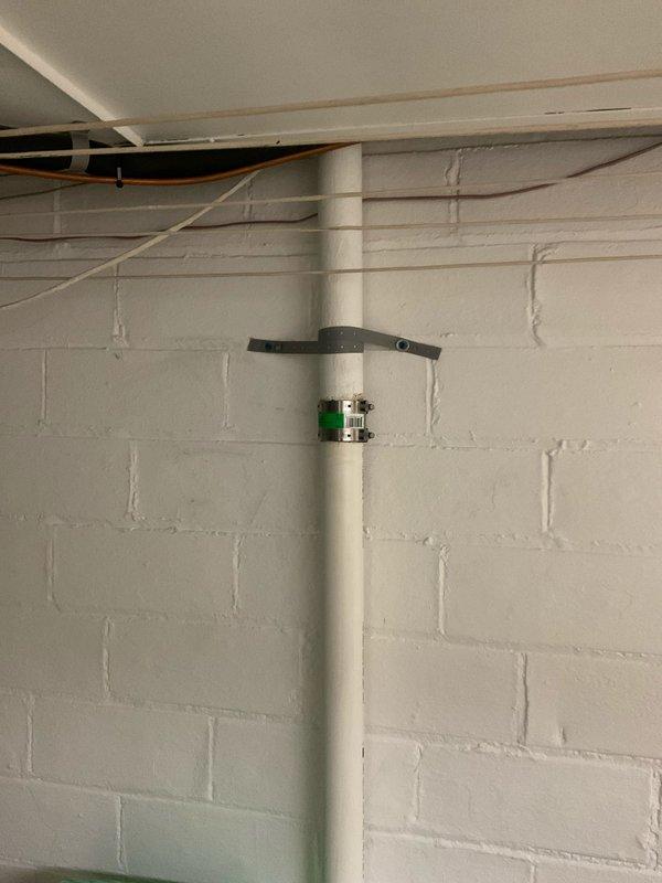 Completed comprehensive plumbing repairs including snaking first and second floor bathroom drains to clear blockages and testing pop-up assemblies for proper operation. Accessed attic space via hallway closet with 6-foot ladder to install air admittance valve on open vent line. In basement, removed existing Fernco coupling on kitchen soil stack and replaced with new 2-inch cast iron to plastic mission band for improved connection integrity. Shut down water supply at main valve and replaced half-inch threaded angle stop valve on cold water supply line serving bathroom faucet. Performed final testing of all plumbing fixtures and connections to verify proper drainage, water flow, and confirm no leaks present throughout system.