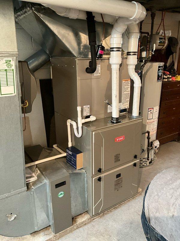 # HVAC Install - Complete System

Completed full residential HVAC system replacement including removal of existing equipment and installation of new Bryant furnace, evaporator coil, outdoor condensing unit, and Ecobee smart thermostat. 

The new furnace was installed in the basement utility area with proper clearances maintained for service access and combustion air requirements. Configured PVC venting system for intake and exhaust, routing pipes vertically through the structure per manufacturer specifications and local code requirements. Connected condensate drainage lines to ensure proper moisture removal from the evaporator coil during cooling operation.

Installed new evaporator coil in the plenum above the furnace, making all necessary refrigerant line connections. Verified proper insulation on suction line to prevent condensation. Connected supply and return ductwork to the new equipment, ensuring secure connections and proper airflow distribution throughout the home.

The outdoo
