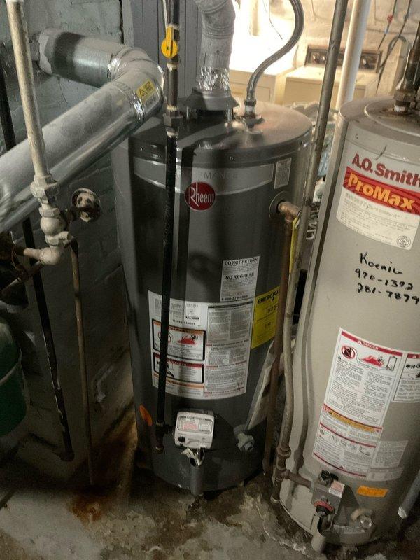 Conducted comprehensive evaluation of three gas-fired tank water heaters in residential basement mechanical room to determine repair versus replacement recommendations. The units varied in age from 5-6 years to 10-12 years old, with visible evidence of water staining on concrete floor surrounding equipment bases indicating potential leak history. Documented existing conditions including manufacturer specifications, model information, and current installation configurations for American, Rheem, and A.O. Smith ProMax units, noting plumbing connections, venting systems, and overall operational status to provide accurate estimate for either individual repairs or complete system replacement.