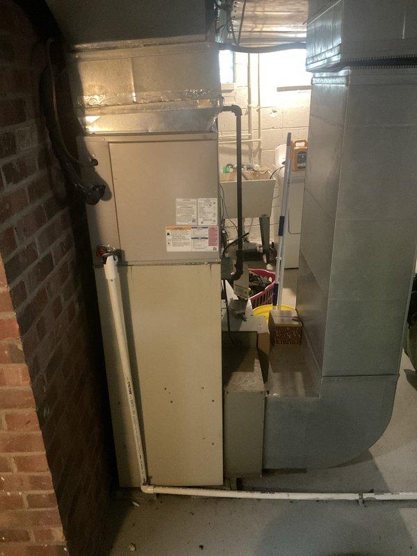Responded to service call for air conditioning system over 10 years old not producing cold air despite fan operation. Upon inspection of the basement-installed HVAC system, conducted diagnostic evaluation of the cooling equipment and verified operational status of all major components including the furnace, evaporator coil assembly, and associated refrigerant lines. Documented equipment specifications and current system configuration with photographic evidence of unit labels, refrigerant information, and TXV components for service records.