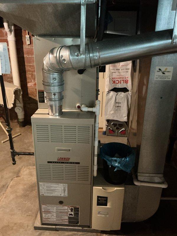 Completed HVAC system assessment for nearly 21-year-old air conditioning unit with no cooling capability. Documented existing Lennox furnace installation and ductwork configuration in basement mechanical room, noting system age and condition to provide comprehensive replacement estimate for aging equipment requiring full system upgrade.