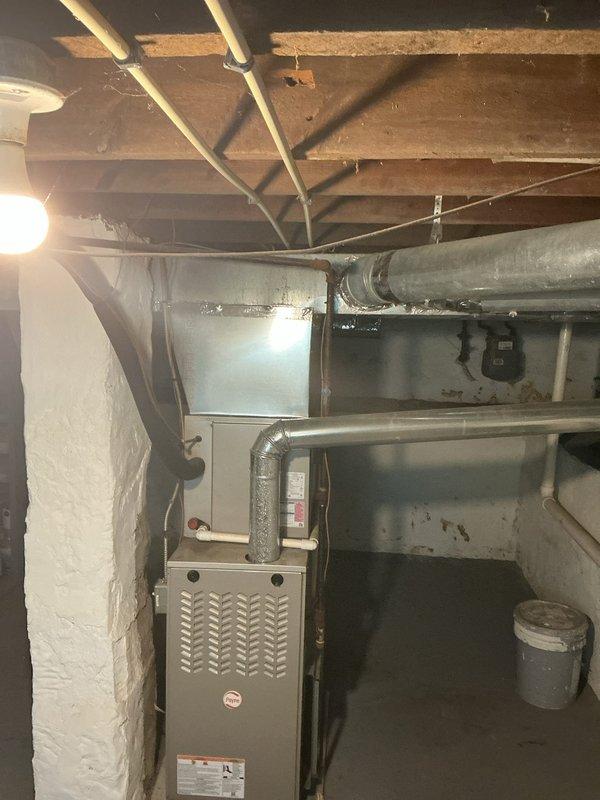 Completed comprehensive HVAC system evaluation for potential home buyer, including thorough inspection of furnace, ductwork, and air conditioning components in basement mechanical room. Assessed supply and return duct system condition, examined flexible ductwork connections, and evaluated overall system integrity and operational status. Documented findings with photographic evidence of furnace unit, ductwork routing, and mechanical connections to provide complete assessment for pre-purchase decision-making purposes.