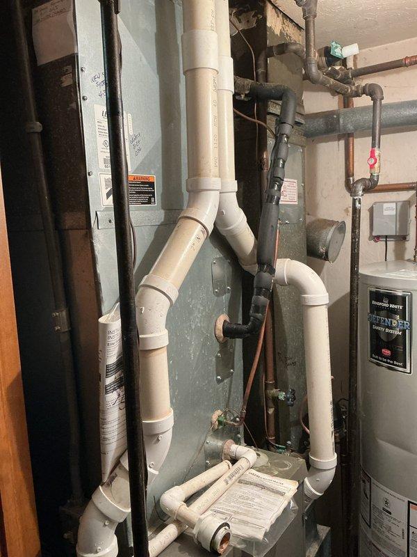 Completed comprehensive HVAC system replacement estimate for residential property requiring new furnace and air conditioning equipment. Assessed existing mechanical room configuration including current furnace unit, water heater, PVC drainage system, and associated copper supply lines to determine optimal replacement specifications and installation requirements for upgraded heating and cooling system.
