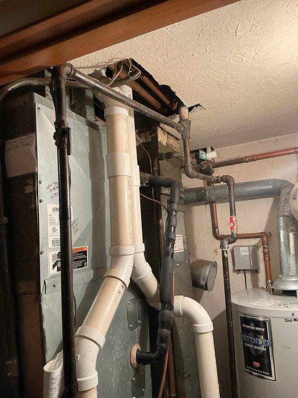 Completed comprehensive HVAC system replacement estimate for residential property requiring new furnace and air conditioning equipment. Assessed existing mechanical room configuration including current furnace unit, water heater, PVC drainage system, and associated copper supply lines to determine optimal replacement specifications and installation requirements for upgraded heating and cooling system.