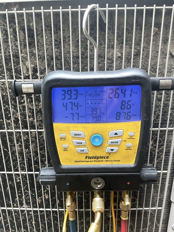 # HVAC Service Report

Responded to no cooling complaint on 1-2 year old air conditioning system. Found extensive ice buildup on evaporator coil and refrigerant lines during inspection. Connected refrigerant manifold gauges to diagnose system pressures and temperatures, which confirmed abnormal operating conditions causing the freeze-up. Primary issue identified as restricted airflow across evaporator coil leading to ice formation on copper tubing and coil surfaces. System required defrosting before proper diagnosis and correction of underlying cause could be completed.