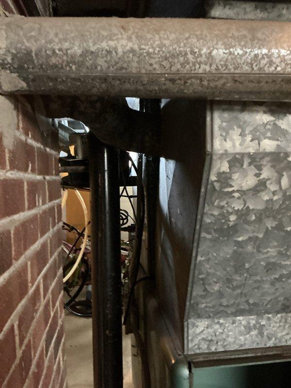 Conducted on-site assessment for replacement estimate of aging 30+ year old furnace system with no cooling capability. Documented existing equipment configuration including green cabinet-style furnace unit, associated ductwork with galvanized sheet metal construction, and adjacent water heating equipment in basement mechanical room. Evaluated current system condition noting visible wear and corrosion on metal components, assessed ductwork connections and routing, and photographed equipment specifications for replacement proposal preparation.