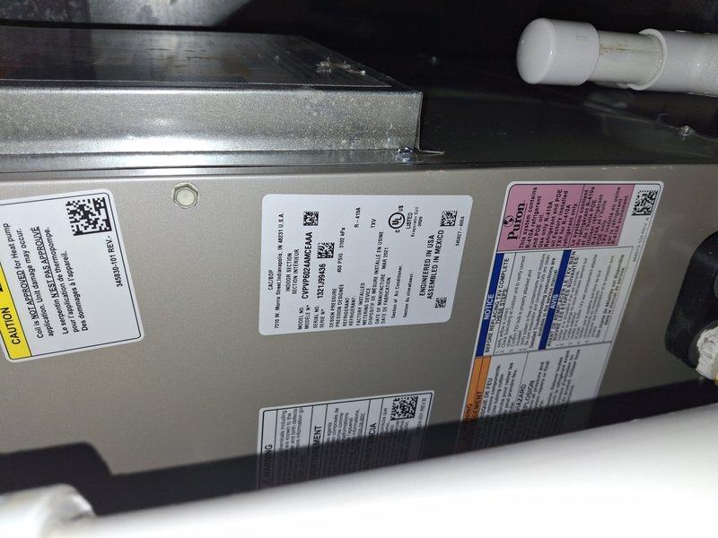 Completed scheduled maintenance on a 6-year-old air conditioning system located in attic space. Performed comprehensive inspection of air handler unit, verified all manufacturer labels and specifications were intact, and examined evaporator coil assembly which showed normal dust accumulation consistent with operational use. All components found in satisfactory working condition with no immediate service needs identified.