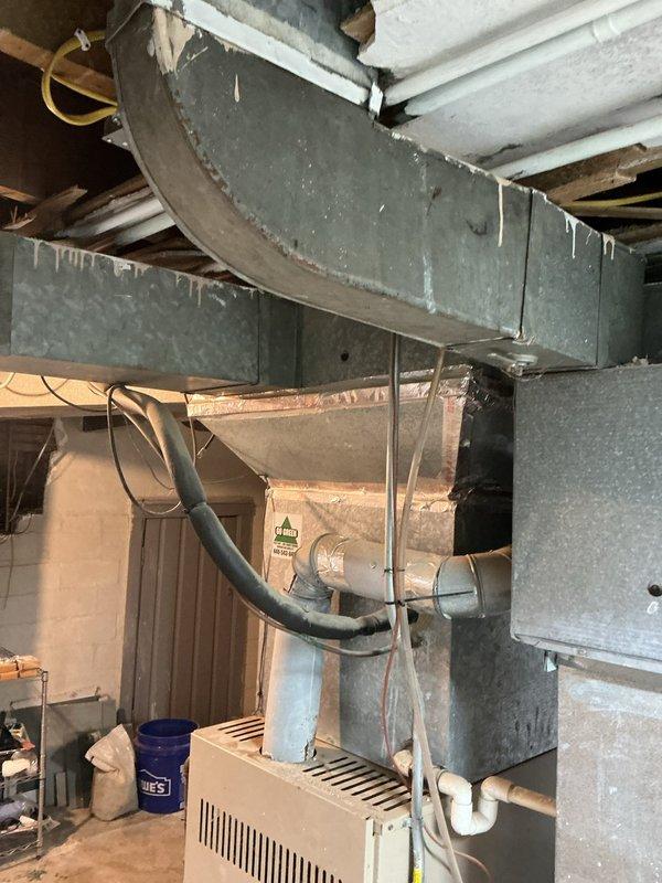 Completed comprehensive HVAC replacement estimate for aging 21+ year old furnace and air conditioning system located in basement utility area. Assessed existing equipment condition, ductwork infrastructure, and calculated load requirements for planned second-story addition to determine proper system sizing and configuration needed to adequately heat and cool expanded living space.