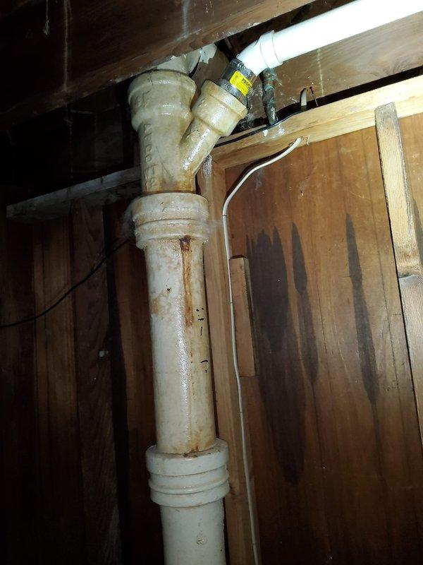Responded to service call for bathtub drainage issue in 78-year-old residential property. Upon arrival, accessed plumbing system through crawl space to assess drain line configuration and identify blockage location. Utilized drain snake equipment to clear obstruction in tub drain line, working through existing access points in the plumbing system. Successfully restored proper drainage flow to bathtub. Inspected visible plumbing components during service, noting age-appropriate wear on drain pipes and fittings. Verified complete drainage function upon completion of snaking procedure.