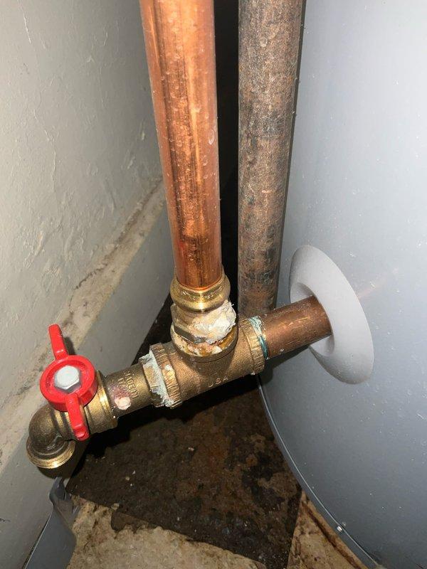 Responded to no hot water condition in 104-year-old home where Lochinvar tank-type water heater displayed "thermopile voltage low" error message. Diagnosed failed thermopile assembly preventing gas valve operation and burner ignition. Replaced thermopile, verified proper millivolt output, tested gas valve functionality, and restored hot water service to entire house.