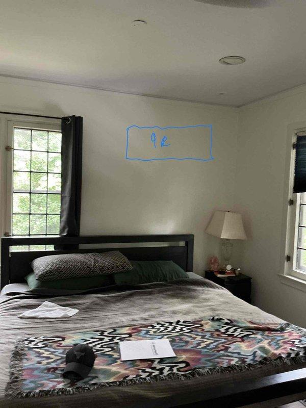 Conducted on-site assessment for mini-split installation in bedroom. Evaluated electrical panel capacity and confirmed adequate breaker availability for new system. Measured and marked proposed indoor unit location on wall above bed at 9-foot height to ensure optimal air distribution and coverage for the space.