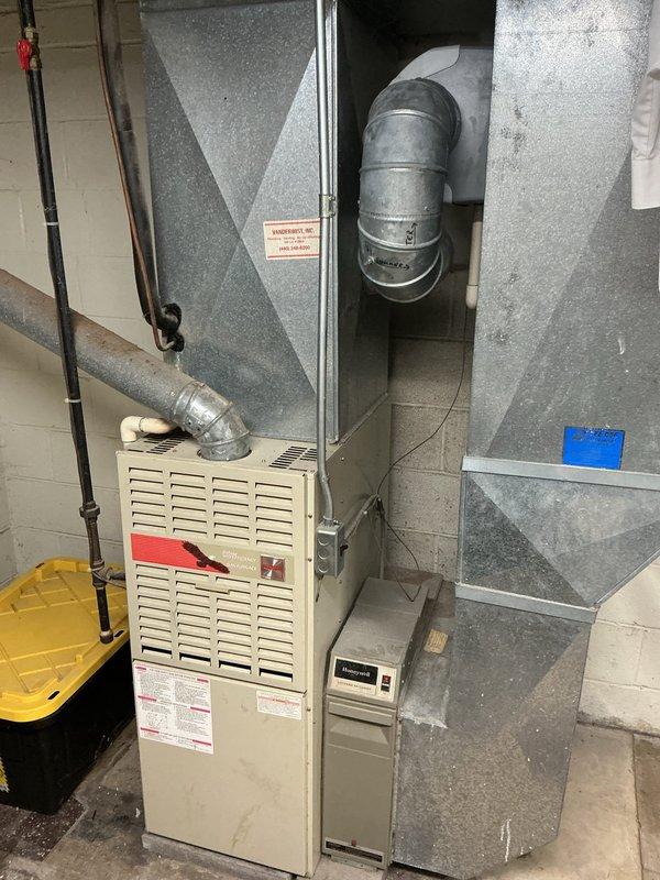 Conducted comprehensive evaluation of 10-year-old residential air conditioning system including outdoor condenser unit and indoor furnace components. Assessed refrigerant levels, system performance, and overall equipment condition to provide replacement estimate. Documented existing HVAC installation with basement furnace unit, ductwork configuration, and exterior condenser unit positioned against building foundation with adequate clearance noted for future replacement considerations.
