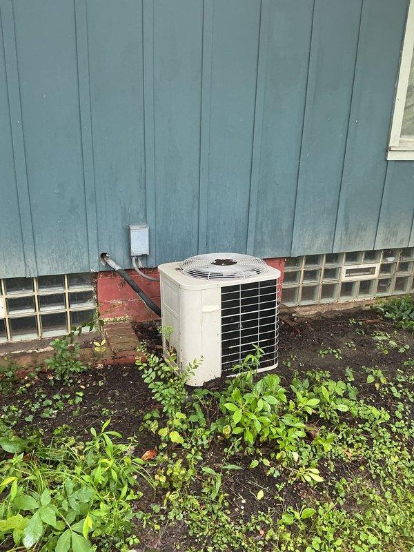 Conducted comprehensive evaluation of 10-year-old residential air conditioning system including outdoor condenser unit and indoor furnace components. Assessed refrigerant levels, system performance, and overall equipment condition to provide replacement estimate. Documented existing HVAC installation with basement furnace unit, ductwork configuration, and exterior condenser unit positioned against building foundation with adequate clearance noted for future replacement considerations.