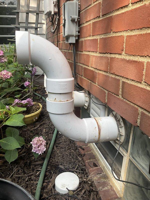 Completed routine AC tune-up on ten-year-old exterior condensing unit. Performed standard maintenance including inspection of electrical connections, refrigerant levels, and operational testing. Identified cracked PVC ventilation pipe at exterior foundation with visible weathering and rust staining at joints; documented condition with photos and advised customer of recommended repair to prevent further deterioration and potential system efficiency issues.